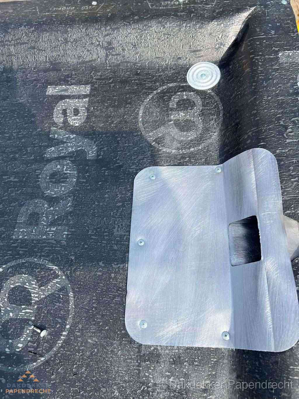 Dakdoorvoer met metalen afvoerplaat op bitumen dak in Papendrecht